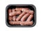 Mini smoked sausages in plastic tray isolated on white