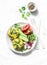 Mini spinach cheddar frittata and vegetables salad on light background, top view. Breakfast table flat lay.
