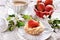 Mini tartlet with cottage cheese and strawberry and cappuccino