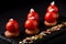 Mini tartlets from berries glazed on top beautifully laid out on a black plate. Modern dessert festive tartlet mousse