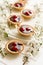 Mini tarts with chocolate and cherries decorated cherry blossom