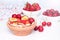 Mini tiny pancakes with straeberries and cherries on white wooden background. Trendy food concept