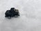 Mini toy maket black CUV car in the snow winter background cold weather problems