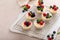 Mini vanilla cheesecakes cooked in a muffin pan served with fresh berries