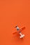 Miniature airplane with the inscription sale on orange background and space for text