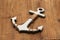 Miniature anchor lying on wooden background