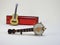 A miniature banjo and a miniature acoustic guitar propped up on a diatonic harmonica