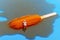 miniature bather man on a melting orange popsicle