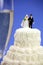 Miniature bride and groom on wedding cake