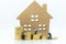 Miniature build: House resting with stack of coins. Image use mortgage and real estate investment