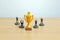 Miniature business concept - businessman lineup rank with golden trophy in the middle