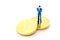 Miniature businessman and Bitcoin on white background