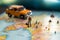 Miniature businessman races with handbag and suitcase near a colorful world map and tiny white car