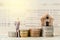 Miniature businessman stand on the stack of coins on book bank b