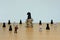 Miniature businessman standing in front horse chess piece at coin stack