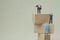 Miniature businessman thinking and standing on step wooden blocks thinking for success in business with copy space