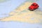 Miniature car driving on a map of Newfoundland Canada