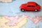 Miniature car driving on a map of Newfoundland Canada