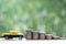 Miniature car model on growing stack of coins money on nature green background, Saving money for car, Finance and car loan,