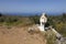 miniature chapel on roadside in mani part of peloponnese in greece with blue sea in the background