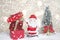 Miniature Christmas Santa cros and Tree on snow over blurred bokeh background,Decoration Image for Christmas Holiday and Happy New