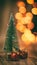 Miniature christmas tree decoration with miniature presents gifts tree decors with sparkling blurred christmas lights waiting for