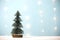 Miniature christmas tree on wooden table over blur bokeh light blue background
