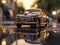 Miniature classic car model with a backdrop of evening sun bokeh.