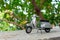 Miniature classic scooter on the cement floor with nature background