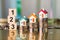 Miniature colorful house on stack coins with wooden block number