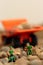 Miniature construction workers on gravel with tipper truck