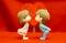 The Miniature Couple dolls Boy and Girl Romantic Kiss on Red Heart Background for valentine`s Day Concept