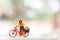 Miniature cyclist standing with bike, World bicycle day concept