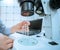 Miniature device lab on chip, microfluidic Devices chip in the hands of a laboratory assistant under a microscope