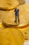 Miniature figure a businessman stands on bitcoin coins.