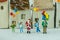 Miniature figure Santa claus standing with happy family holding