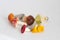 Miniature figures of aspen mushrooms, blueberry, chanterelle, fly agaric, syroezhka, pale toadstool on a white isolated background