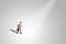 Miniature figurine character as businessman walking lonely on footpath.