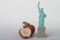 Miniature figurine of the Liberty statue with a big apple,  symbols of New York city