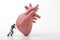 Miniature figurine of a man pushing a giant heart