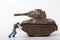 Miniature figurine of a man pushing a war tank