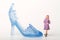 Miniature figurine of a woman with a giant shoe