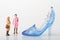 Miniature figurine of a woman with a giant shoe