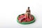 Miniature figurine of a woman sitting on a giant watermelon slice