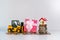 Miniature forklift truck lift up pink gift box with mini house on stack coins