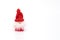 Miniature gnome or Santa in red hat and with fluffy beard isolated on white