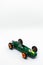 Miniature green race car with number 3 isolated on a white background