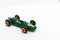 Miniature green race car with number 3 isolated on a white background