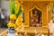 Miniature guardian spirit house. Small buddhist temple shrine, colorful flower garlands. San phra phum erected to bring fortune.