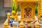 Miniature guardian spirit house. Small buddhist temple shrine, colorful flower garlands. San phra phum erected to bring fortune.